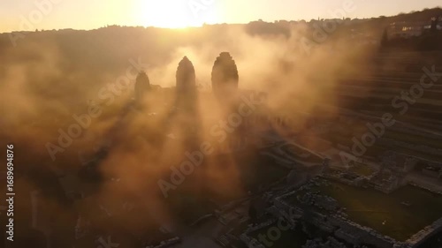 Misty sunrise over ancient inca ruins in the andes mountains