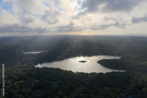 Wallpaper Mural Beams of sunlight fall through low clouds illuminating Pilgrim Lake in Orleans on Cape Cod. This scenic Massachusetts peninsula harbors many ponds and lakes left over from the last glacial period. Torontodigital.ca