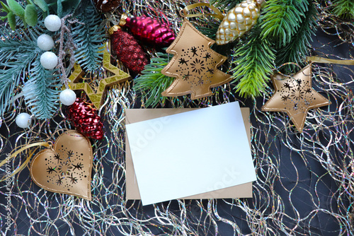 Christmas card design made of fir branches, tinsel and Christmas balls