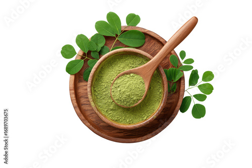 Wooden bowl filled with green powder, topped with fresh leaves, and a wooden spoon