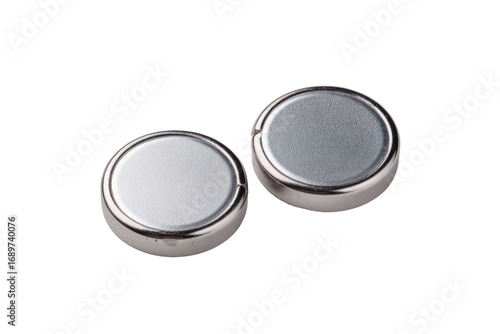 Two round, metallic, button-style batteries sit side-by-side, slightly angled, against a plain black background.  They are a silvery-gray color