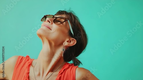 Wallpaper Mural Woman in sunglasses and casual beach attire posing for a with a joyful expression. Torontodigital.ca