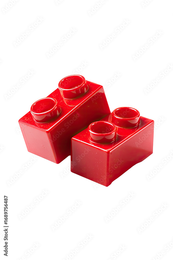 Fototapeta premium Two red plastic building blocks, slightly angled, against a black background. They are simple rectangular shapes with two small, round holes on each