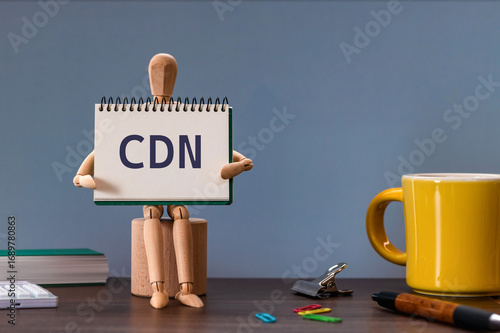 There is notebook with the word CDN. It is an abbreviation for Content Delivery Network as eye-catching image.