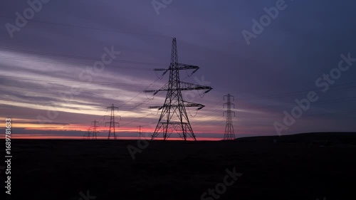 Sunrise Over Yorkshire Pennines: Electricity Pylons and Power Lines Against a Dramatic Sky