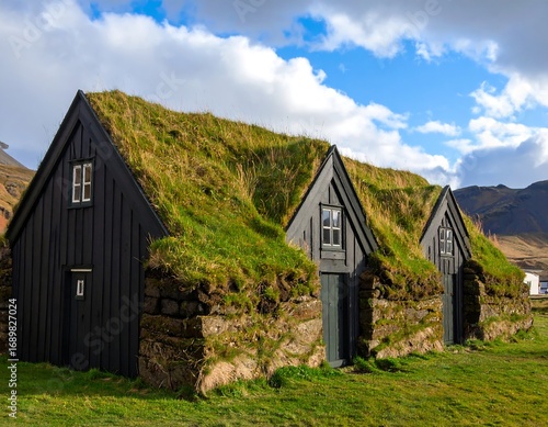 Traditional Icelandic turf houses under a partly cloudy sky