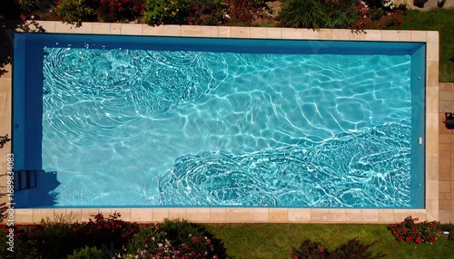 Aerial View of a Rectangular Swimming Pool with Teal Water