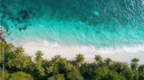 Aerial view of turquoise coastal waters with white sand, capturing the beauty of a tropical paradise.