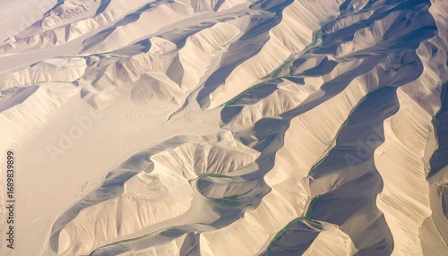 Fototapeta Naklejka Na Ścianę i Meble -  Aerial View of Beige Sand Dunes with Repeating Micro-Ripples