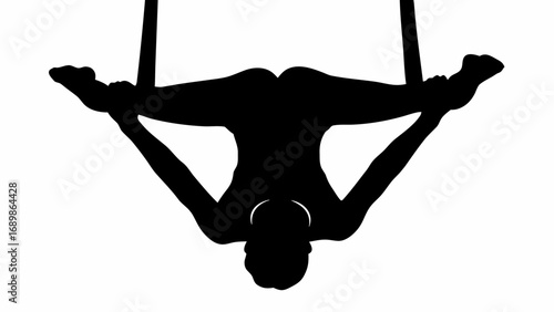 Silhouette of aerialist performing a split on aerial silks against a white background in a studio setting