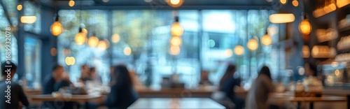 Wallpaper Mural Blurred image of people sitting and socializing in a warm, softly lit modern cafe with large windows and hanging lights creating a cozy, relaxed atmosphere Torontodigital.ca