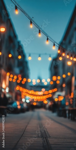 Blurred street perspective view featuring string lights illuminating the path, casting a warm glow against the cool city tones