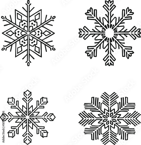 Four intricate snowflakes arranged on a white surface, showcasing unique crystalline structures and delicate patterns, creating a wintery and festive atmosphere.