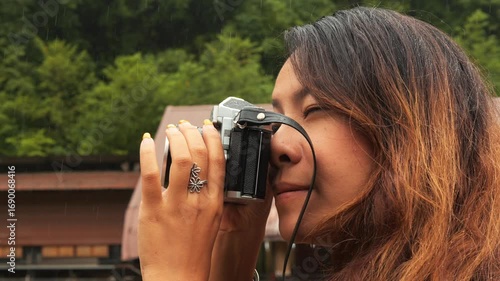 Portrait of Young Woman with Vintage Camera Standing on Suspension Bridge in Chiang Mai Thailand