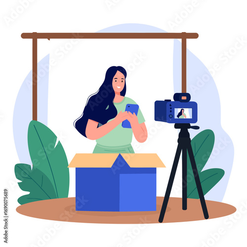 Woman filming unboxing video with phone.