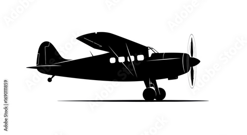 Silhouette of a Classic Propeller Airplane in Flight.