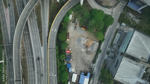 Aerial View of Highway Intersection with Construction Area and Green Surroundings in July