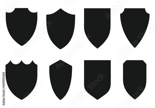Collection of eight diverse black shield silhouettes for emblem and heraldic designs