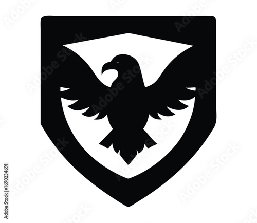 Black silhouette of a fierce eagle spreading wings within a shield emblem