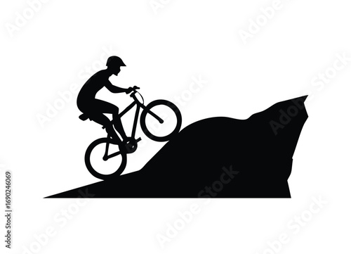 Dynamic silhouette of mountain biker ascending a steep trail edge