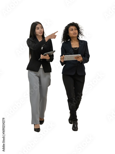 Two Professional Women Walking and Discussing in a Modern Office