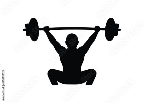 Silhouette of a strong weightlifter performing a powerful overhead squat with a barbell
