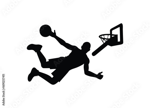 Dynamic silhouette of a basketball player slam dunking into the hoop action shot