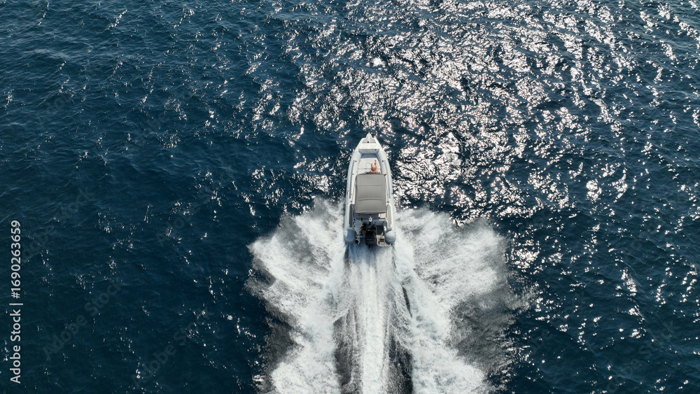 Obraz premium Aerial drone top down photo of luxury inflatable rib speed boat cruising in mediterranean sea