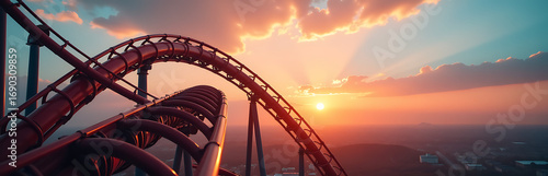 twisted roller coaster tracks ascending warm golden sunset wispy clouds tinted pink orange across clear blue
