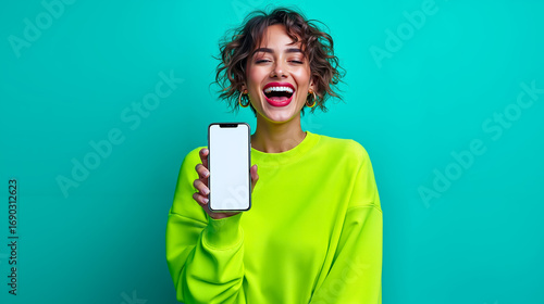A woman in a bright yellow sweatshirt holding up a white phone