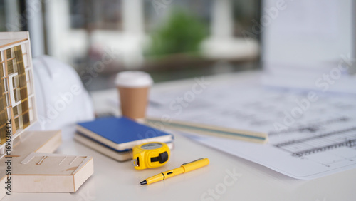 Wallpaper Mural Architectural design planning workspace featuring building model blueprints safety helmet measuring tape pen for project development Torontodigital.ca
