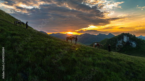Fotografija Dawn on the high mountain peaks of Ha Lang area, with pack horses and people going to work