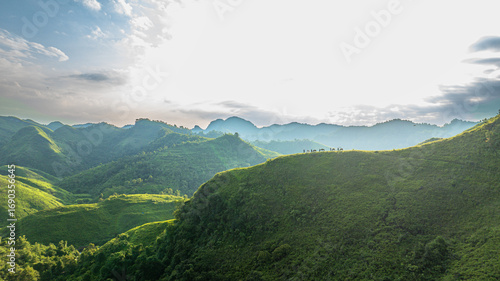 Slika na platnu Dawn on the high mountain peaks of Ha Lang area, with pack horses and people going to work