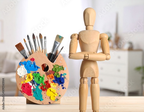 Wooden mannequin with art supplies