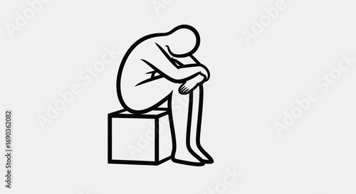 Depressed person sitting on a box
