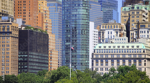 skyscrapers of Lower Manhattan in New York city and the waving american flag