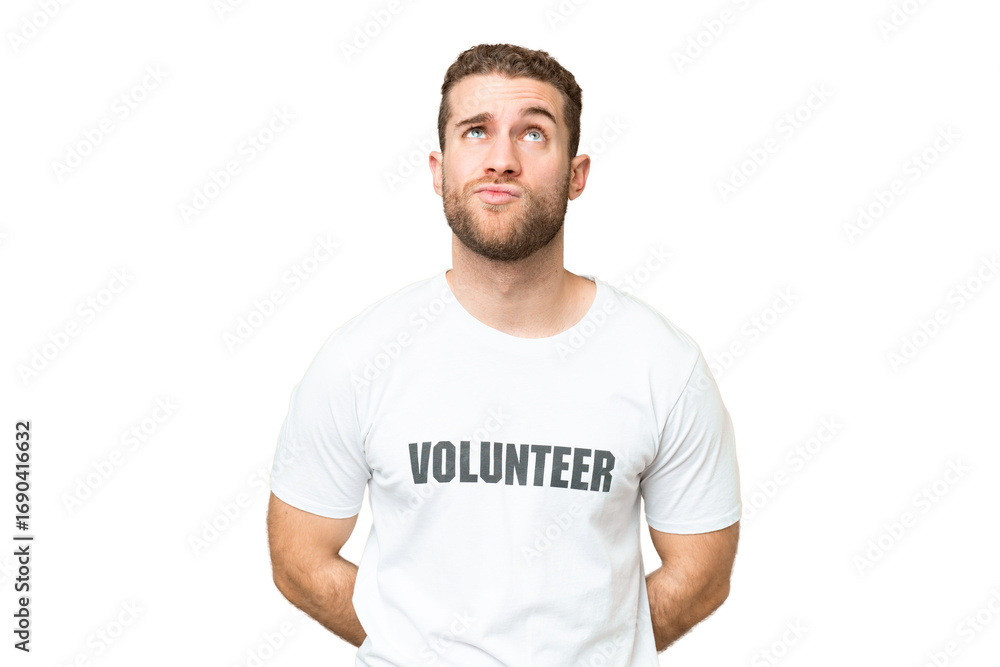 Fototapeta premium Young volunteer man over isolated chroma key background and looking up