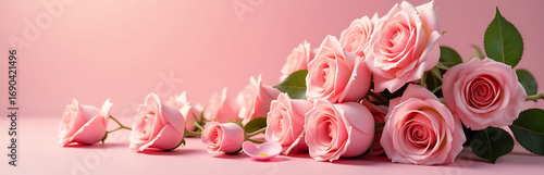 lush rose bouquet overflowing velvety petals soft pastel hues spills across warm gentle pink background bathed soft diffused