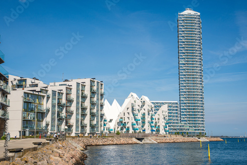 View of the Lighthouse complex in Aarhus, Denmark, featuring the iconic skyscraper rising on the waterfront, symbol of modern urban development and coastal skyline.