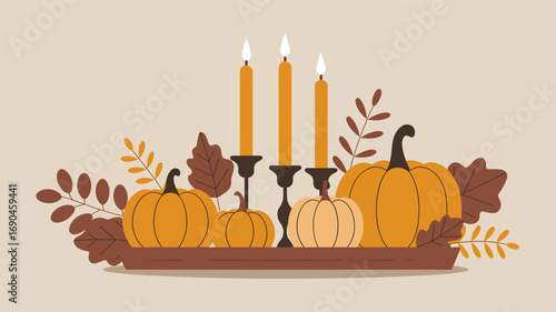 Cozy autumn harvest arrangement featuring pumpkins and lit candles on a tray with fall leaves silhouette