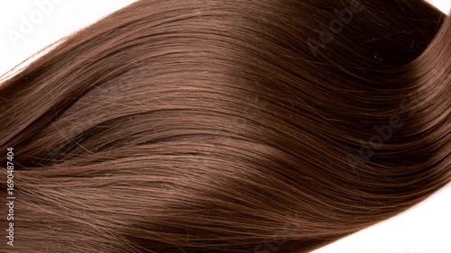 Close up view of glossy flowing dark brown hair on white background