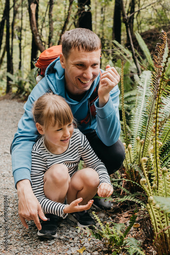 A father and daughter explore a nature trail on a forest path, adventure. Travel. New Zealand