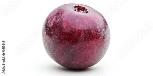 A single, ripe plum rests on a white surface. The plum is a deep, rich burgundy color with a textured skin and a small, visible indentation at the stem end. 