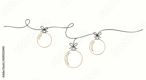 Elegant golden Christmas ornaments hanging on a delicate string for holiday decor and festive designs