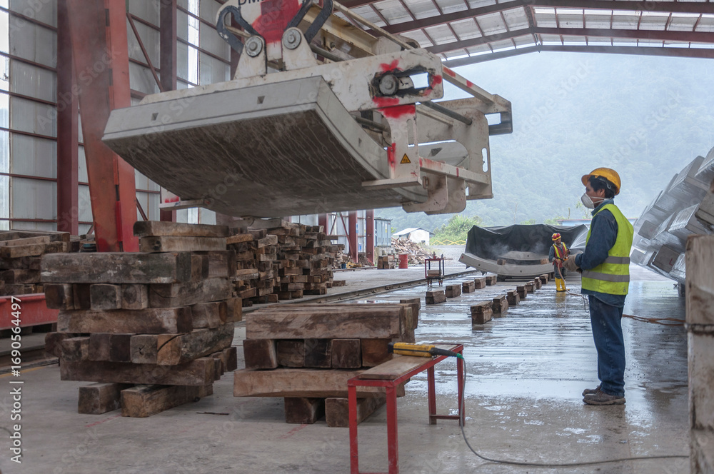 Naklejka premium Industrial workers in manufacturing plant with heavy machinery for concrete tunnels covers. Machine, concrete, factory, warehouse, construction, site, environment, engineering, teamwork, workplace