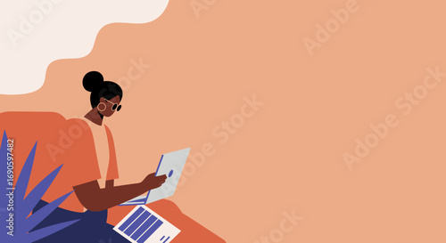 Stylish woman working on her laptop from a comfortable home or remote office setting, embodying modern productivity and flexible work arrangements.