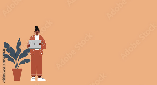 A stylish, modern woman works remotely with her laptop next to a houseplant. Ideal for concepts of productivity, freelance, or remote work lifestyle.