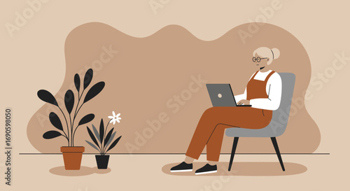 Senior woman confidently uses a laptop at home, embracing technology for remote work, online learning, or staying connected. Modern lifestyle and digital inclusion.