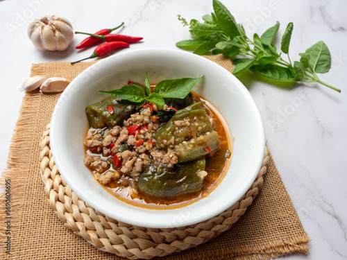 Stir Fried eggplant with minced pork, chili and basil leaves at close up view - Thai food