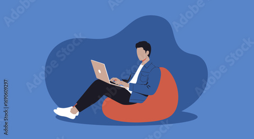 Focused man working on a laptop, comfortably seated on a bean bag chair. Depicts remote work, flexible lifestyle, productivity, and modern business.